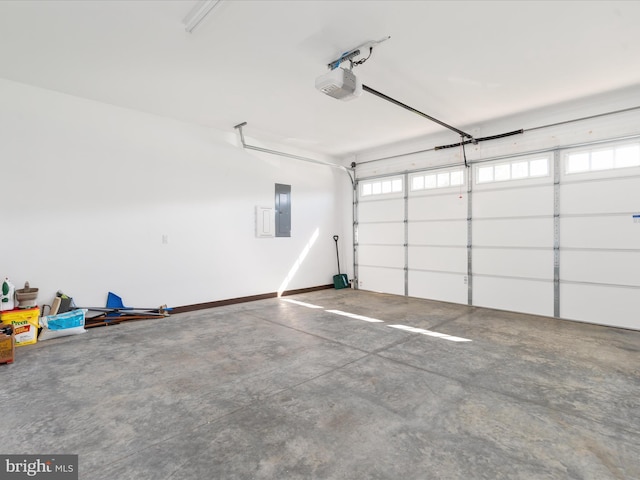 garage with a garage door opener and electric panel