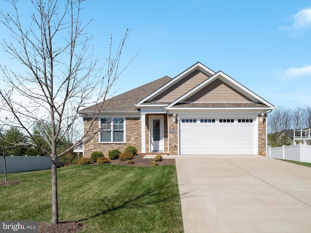 view of front of house with an attached garage, stone siding, concrete driveway, and fence