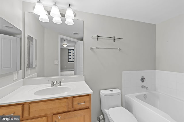 bathroom with vanity, a bath, visible vents, and toilet