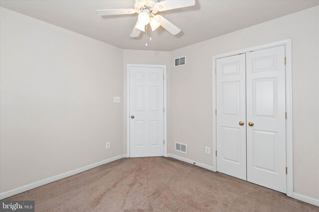unfurnished bedroom featuring baseboards, visible vents, a closet, and carpet