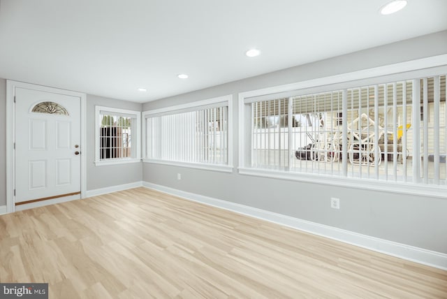 entryway with baseboards, wood finished floors, and recessed lighting