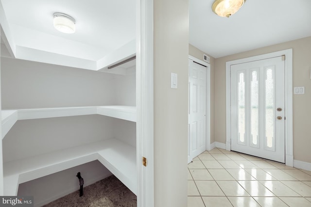 entrance foyer with baseboards, visible vents, and tile patterned floors