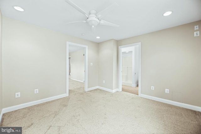carpeted spare room with a ceiling fan, baseboards, and recessed lighting