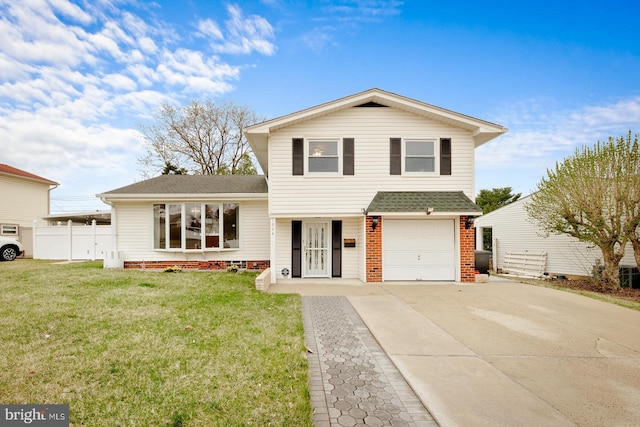 split level home with driveway, a front yard, fence, a shingled roof, and a garage