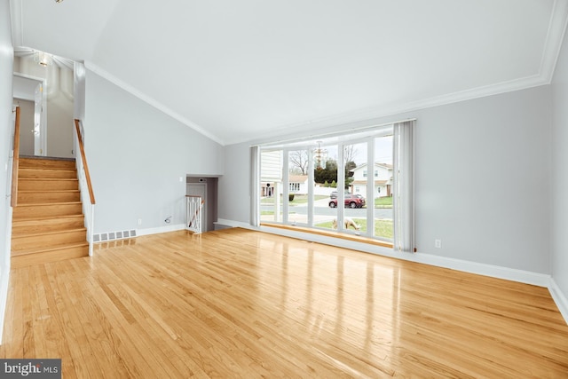 unfurnished living room with visible vents, baseboards, ornamental molding, wood finished floors, and lofted ceiling