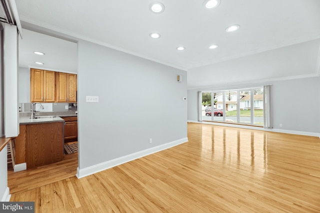 living room with baseboards, light wood-style flooring, and crown molding