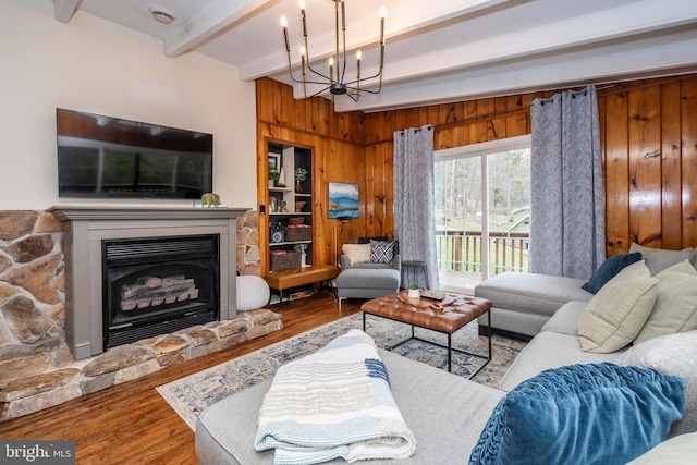 16 Jrs Dr, Mc Henry, MD 21541 - living area with an inviting chandelier, wood walls, wood finished floors, beam ceiling, and a stone fireplace