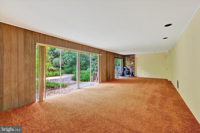 1408 Margarette Ave, Baltimore, MD 21286 - unfurnished living room featuring wooden walls, carpet flooring, and a wood stove