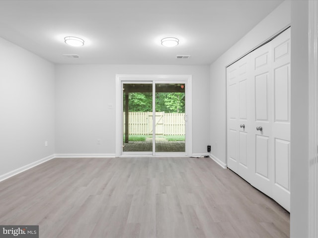 12617 Monarch Ct, Woodbridge, VA 22192 - unfurnished bedroom with access to outside, light wood-style floors, baseboards, and a closet