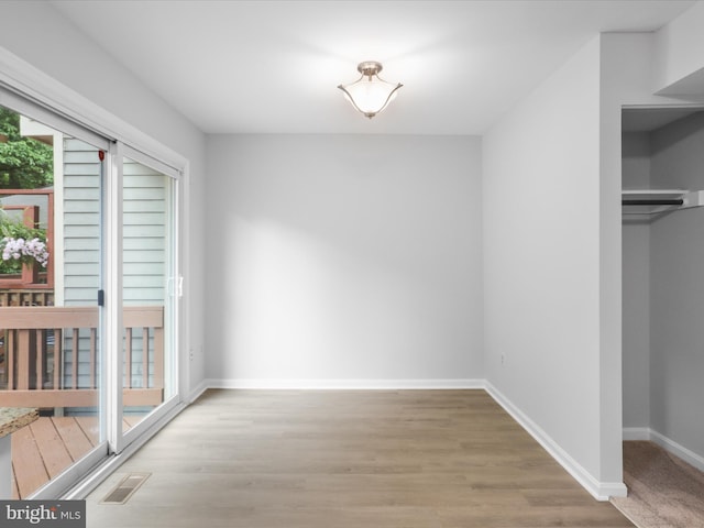 12617 Monarch Ct, Woodbridge, VA 22192 - unfurnished dining area featuring wood finished floors and baseboards