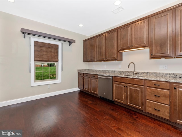 kitchen with stainless steel dishwasher, a sink, dark wood finished floors, baseboards, and visible vents