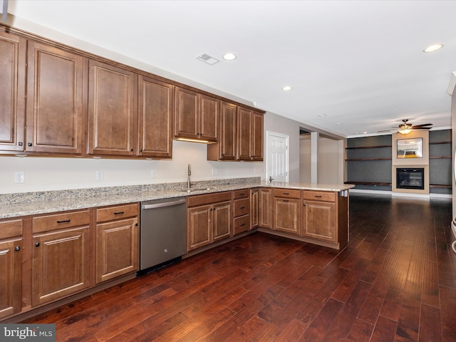 kitchen featuring a peninsula, a sink, visible vents, dishwasher, and dark wood-type flooring