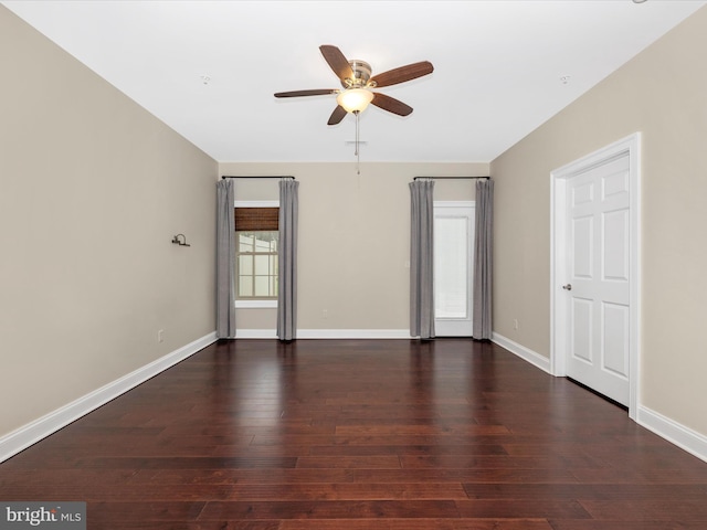 unfurnished room featuring visible vents, baseboards, a ceiling fan, and dark wood-style floors