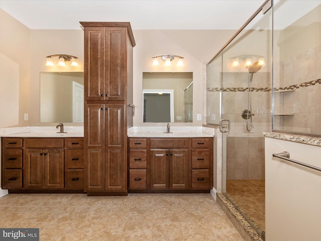 full bath featuring vanity, tile patterned flooring, and a stall shower