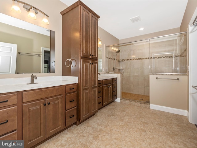 full bath with visible vents, vanity, and tiled shower
