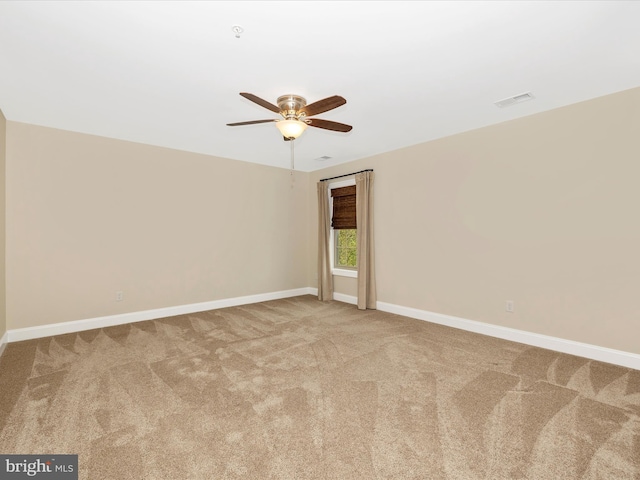 unfurnished room with ceiling fan, baseboards, visible vents, and carpet