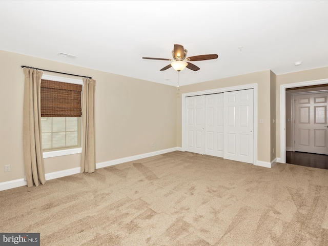 unfurnished bedroom with baseboards, visible vents, a closet, and carpet flooring