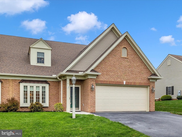 view of front of home featuring a front lawn, driveway, brick siding, and a garage