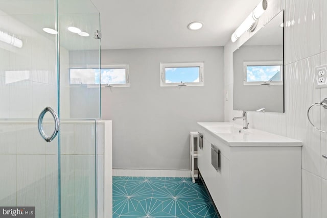 full bath featuring tile patterned flooring, a shower stall, and vanity
