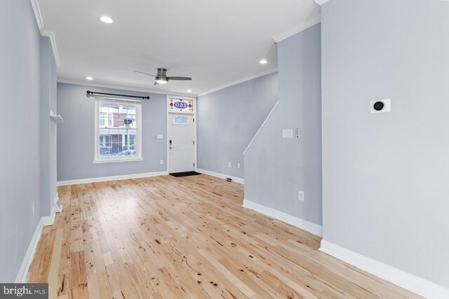 unfurnished living room featuring crown molding, light wood-style floors, ceiling fan, baseboards, and recessed lighting