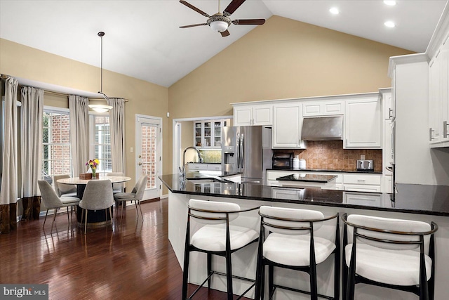kitchen with a sink, white cabinetry, ceiling fan, stainless steel fridge with ice dispenser, and under cabinet range hood