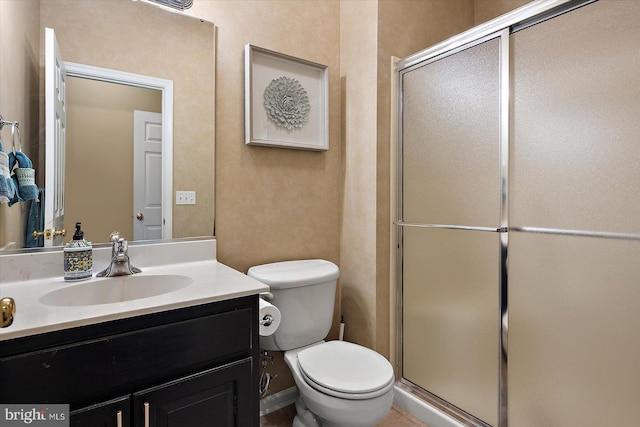 full bath featuring a shower stall, toilet, and vanity