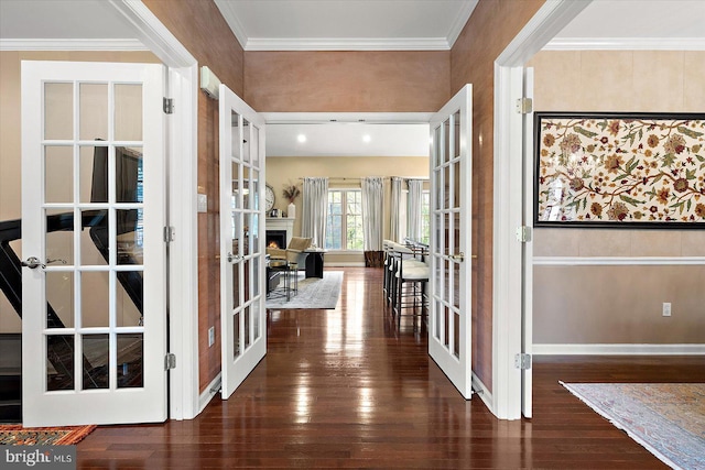 entrance foyer featuring hardwood / wood-style floors, crown molding, baseboards, and french doors