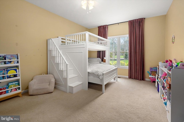 carpeted bedroom featuring baseboards