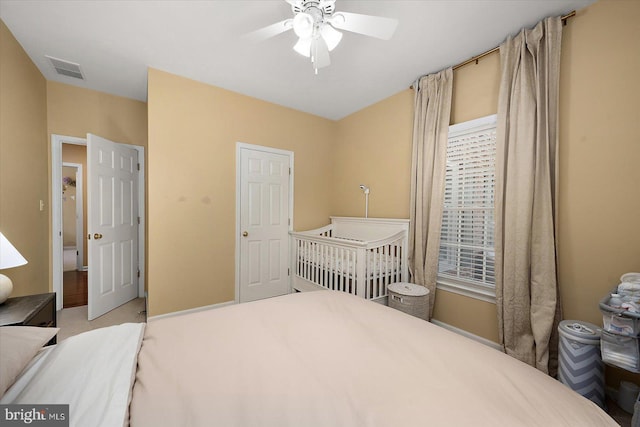 bedroom with a ceiling fan, visible vents, and carpet