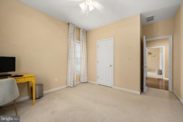 office featuring baseboards, a ceiling fan, visible vents, and carpet flooring