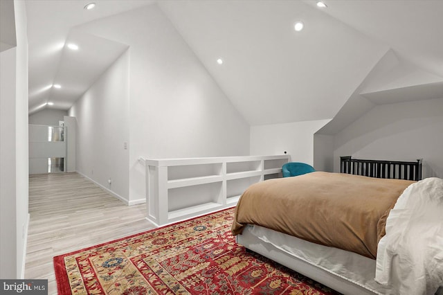 bedroom featuring lofted ceiling, baseboards, wood finished floors, and recessed lighting