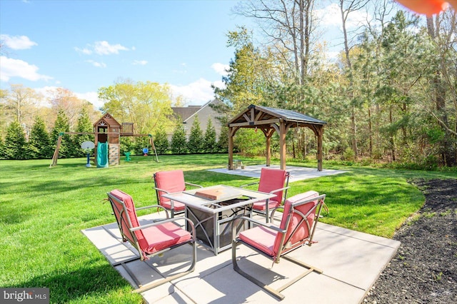 view of patio with a fire pit, a gazebo, and a playground