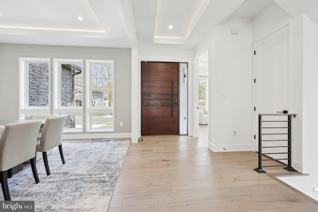 entryway featuring light wood finished floors, baseboards, and recessed lighting