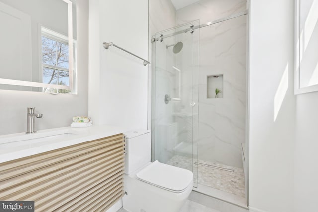 full bathroom featuring a marble finish shower, vanity, and toilet