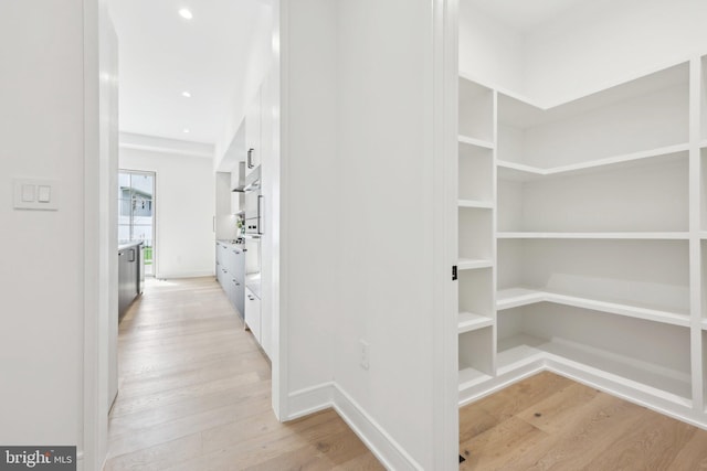 interior space with baseboards, light wood-style floors, and recessed lighting