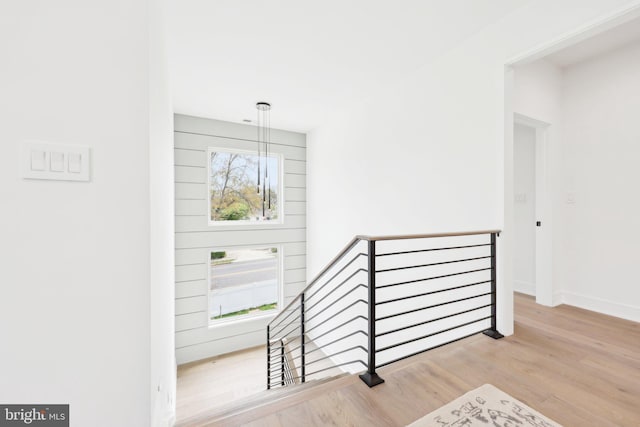 stairs featuring baseboards and wood finished floors