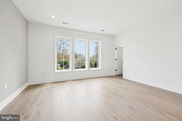 empty room with recessed lighting, baseboards, visible vents, and light wood-type flooring