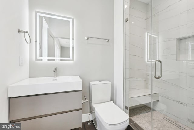 bathroom featuring toilet, vanity, and a marble finish shower