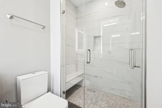 full bathroom with toilet and a marble finish shower