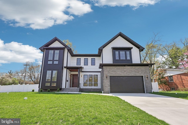 view of front of home featuring fence, driveway, stone siding, a front yard, and a garage