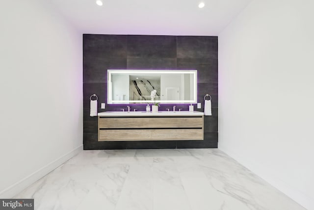 room details featuring baseboards, a sink, and recessed lighting