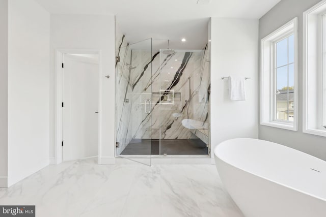 full bath with a freestanding bath, a healthy amount of sunlight, marble finish floor, and a marble finish shower