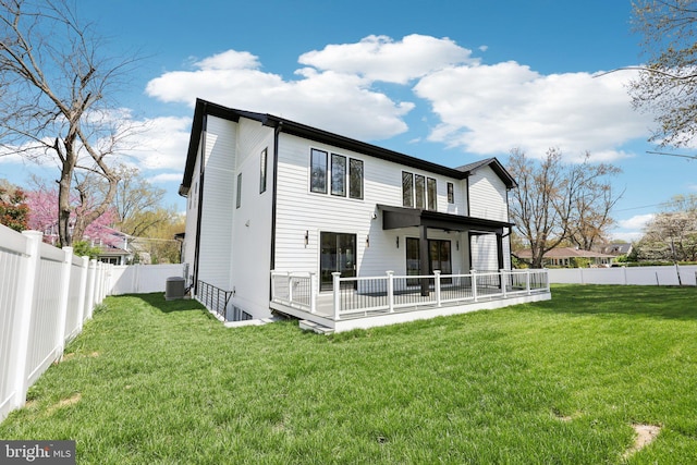 back of house with a fenced backyard, a yard, and cooling unit