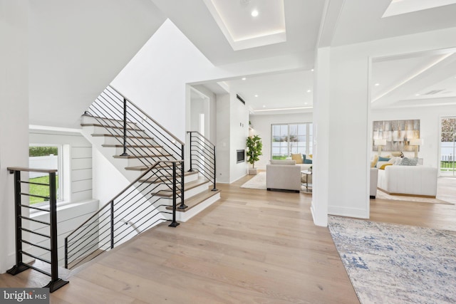 foyer with wood finished floors, recessed lighting, and stairs