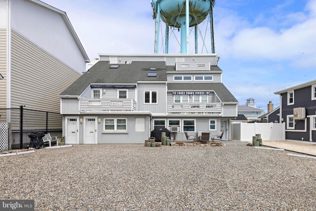 111 W 18th St Unit 2, Ship Bottom, NJ 08008 - back of house with a shingled roof, fence, and board and batten siding