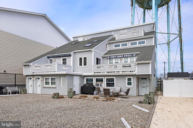 111 W 18th St Unit 2, Ship Bottom, NJ 08008 - back of property with an outdoor hangout area, fence, roof with shingles, a patio, and a balcony