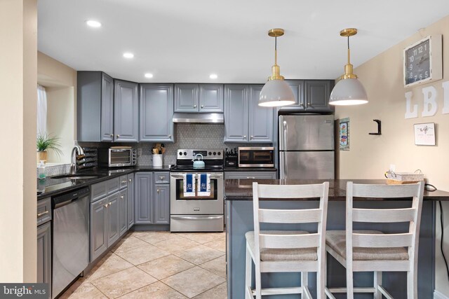 111 W 18th St Unit 2, Ship Bottom, NJ 08008 - kitchen featuring a sink, backsplash, appliances with stainless steel finishes, under cabinet range hood, and dark countertops