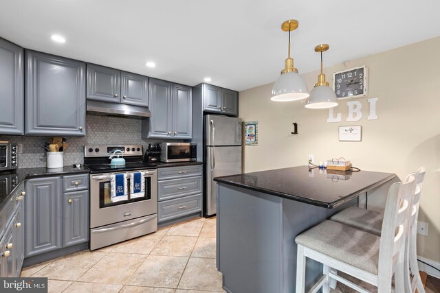 111 W 18th St Unit 2, Ship Bottom, NJ 08008 - kitchen featuring gray cabinets, dark countertops, under cabinet range hood, and stainless steel appliances