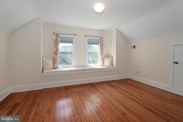 bonus room with visible vents, baseboards, lofted ceiling, and hardwood / wood-style flooring