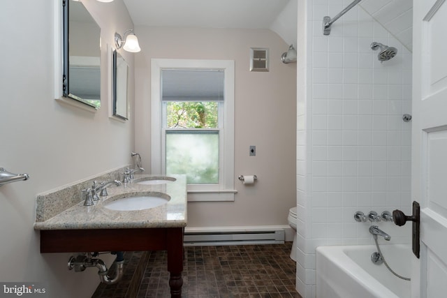 bathroom with a sink, washtub / shower combination, baseboard heating, and visible vents